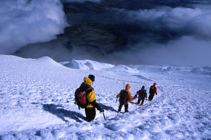 Climbers descending after a successful ascent of Volcan Cotopaxi (5897m).