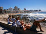 Four people enjoying the beach views.