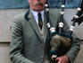 Piper playing bagpipes in Royal Mile.