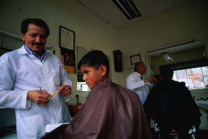 Young boy gets a haircut in Quito.