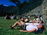 Tourists rest on the grounds of the 500 year old Inca city of Machu Picchu, discovered in 1911 by American Hiram Bingham (with a lot of help from local farmer Melchior Artega).