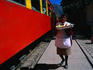 Food vendor on the Ollantaytambo station platform with the Cusco-Aguas Calientes train bound for the lost Inca city of Machu Picchu.