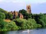 Sculler rowing on Trent river in front of Wilford Church.