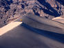 Hiker walking on ridge of Eureka Sand Dunes.