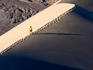 Hiker on ridge of Eureka Sand Dunes.