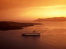 Cruise ship in bay at sunset.
