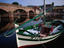 Fishing boat moored near an old bridge (ponte) in Bosa.