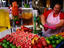 Woman working at juice stand at carmel Market.