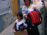 A mother and daughter holding woven cloths at the Indian Craft Market