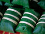 Overhead of balls of steamed rice wrapped in banana leaves, Talaat Sao market.