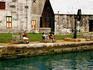 People relaxing on quay of Maritime Museum, Royal Naval Dockyard.