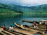 Villagers in dugout canoes at market.