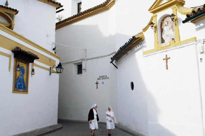 Nuns in alley near Casa de los Fernandes de Cordobaa and Convento de Capuchinos.