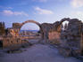 Saranda Kolones ruins at dusk in Kato Phaphos with the harbour in the background.