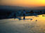 Turkish women at sunset at Pamukkale, which was formed when warm calcium-rich mineral water cascaded over the cliff edge, cooling and depositing its calcium in the process.  The calcium built natural shelves, pools and stalactites.