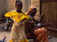 A woman with children in traditional colourful clothing.