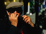 Elderly man from Eger playing the harmonica.