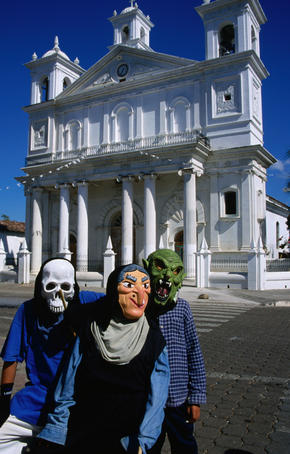 Children of Suchitoto in front of the Santa Lucia Church wearing ghoulish masks for the Patron Saints Festival.
