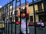Young local boy climbing the iron fence of the San Francisco church in Lima.