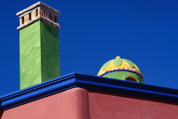 Colourfully painted chimney and dome of a house in San Miguel de Allende.