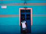 Maya woman in traditional dress at door in Motul.