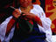 Otavaleno Indian woman crocheting a bag on Poncho Plaza in Otavalo.