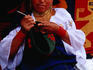 Otavaleno Indian woman crocheting a bag on Poncho Plaza in Otavalo.