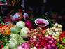 Otavaleno Indian woman and her fresh vegetable stall at the Poncho Plaza in Otavalo.