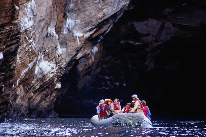 Tourists viewing wildlife from panga (small dinghy) at Punta Vicente Roca.