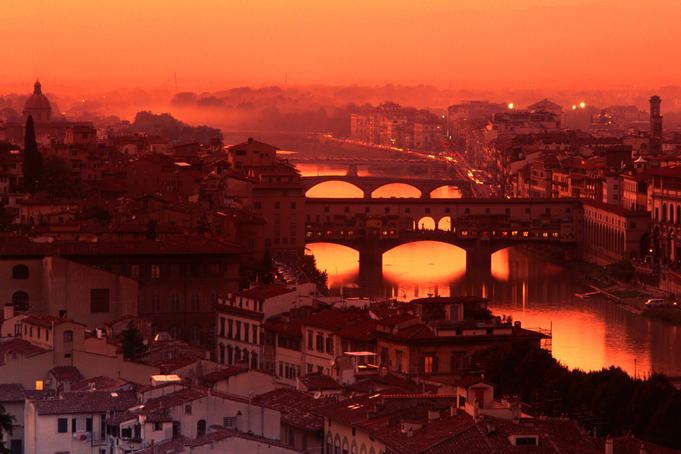 High angle view of Arno River and Ponte Vecchio at sunset.