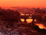 High angle view of Arno River and Ponte Vecchio at sunset.