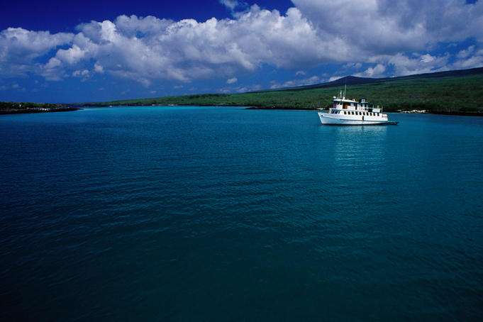 Cruise boat anchored in bay between Lobos and San Cristobel Islands.