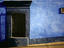Barred window in painted building, Calle de Allende.
