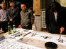 Men watching calligrapher at work, Calligraphy Street.