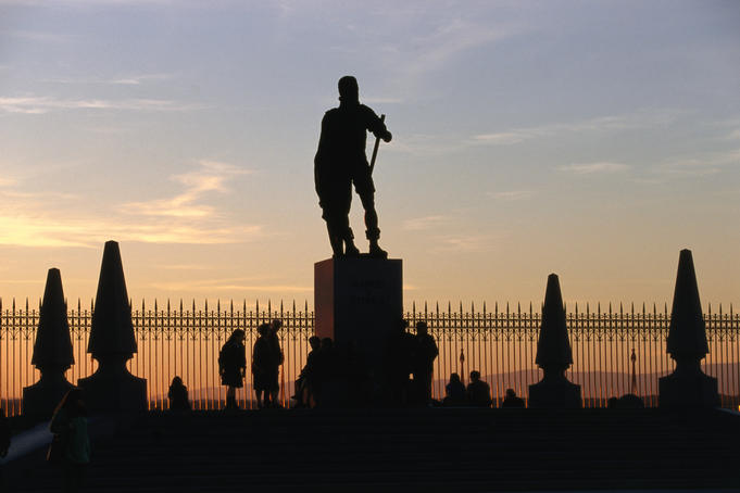 Silhouetted statue and trees at Royal Palace.