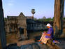 Woman sitting wih book at Angkor Wat.