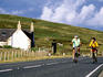 Cyclists on road at Mid Yell near Windhouse (Shetlands most haunted house).