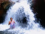 Woman in waterfall at Carbon Creek, Colorado River.