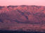 Sandia Mountains turn pink with alpenglow at sunset.