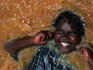 Child playing in water after rain.