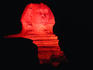 The Sphinx lit by red light.