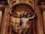 Statue of Saint Sebastian in a gilded niche of a church.