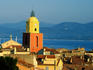 Village rooftops and churchtower in morning.