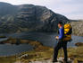 Hiker looking at Coomadavallig Lake with Hungry Hill in the distance.