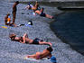 People sunbathing on Arkadia Beach with waters of Black Sea.
