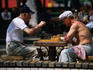 Men playing chess under chestnut trees in Shevchhenko Park.