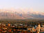 Overhead of city with mountain in background.
