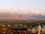 Overhead of city with mountain in background.