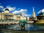 The fountain in the middle of Trafalgar Square with the National Gallery and St Martin-in-the-Fields church in the background - London, Greater London, England