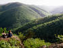Overhead of forested hills and visitors at Twenty Minute Cliff.